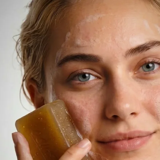 Close-up of the female lead, wet skin, product in hand