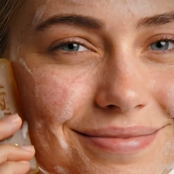 Close-up of the same lead, lather on the cheek, smiling